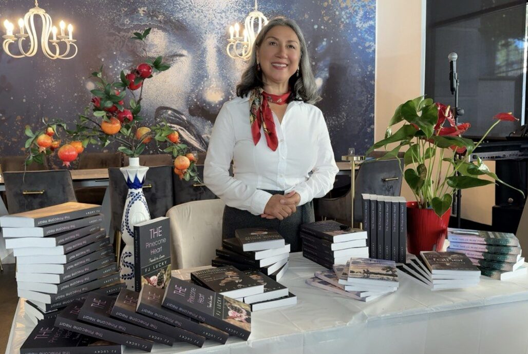 Author FJ Lucky signing copies of a romance novel